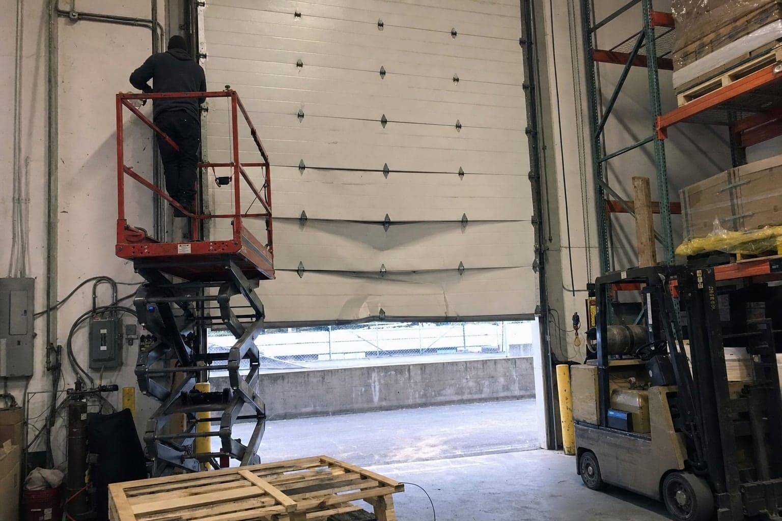 Replacing a bent section on a large warehouse door